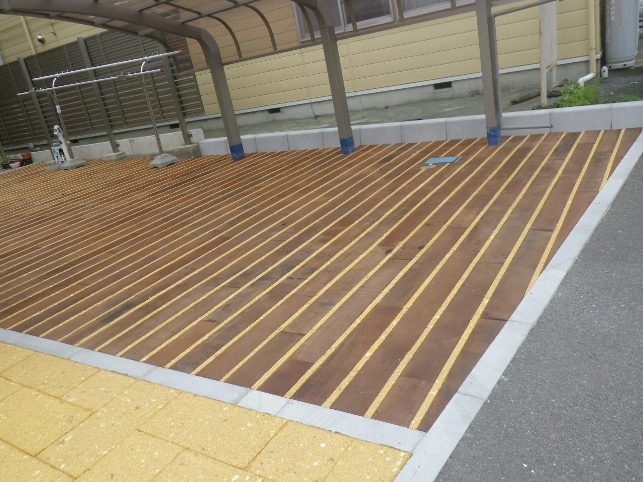 舗装広場と木床を直線で切り替えた境界