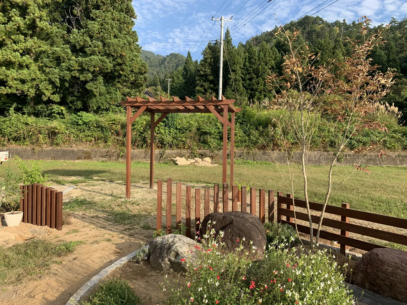植栽と景石の間に配置したパーゴラと木柵