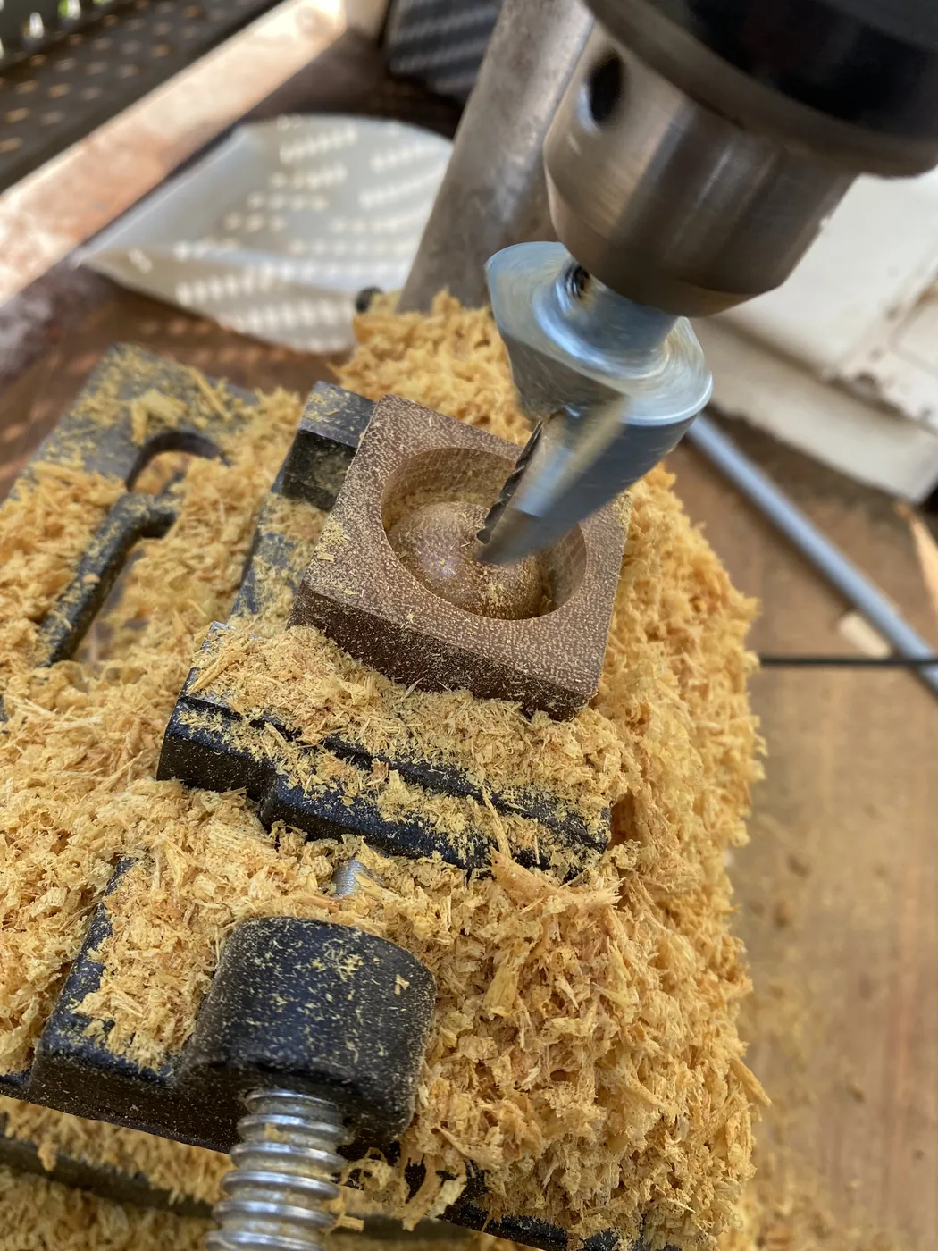 固定したウリンの木片へ中心穴を加工している工程