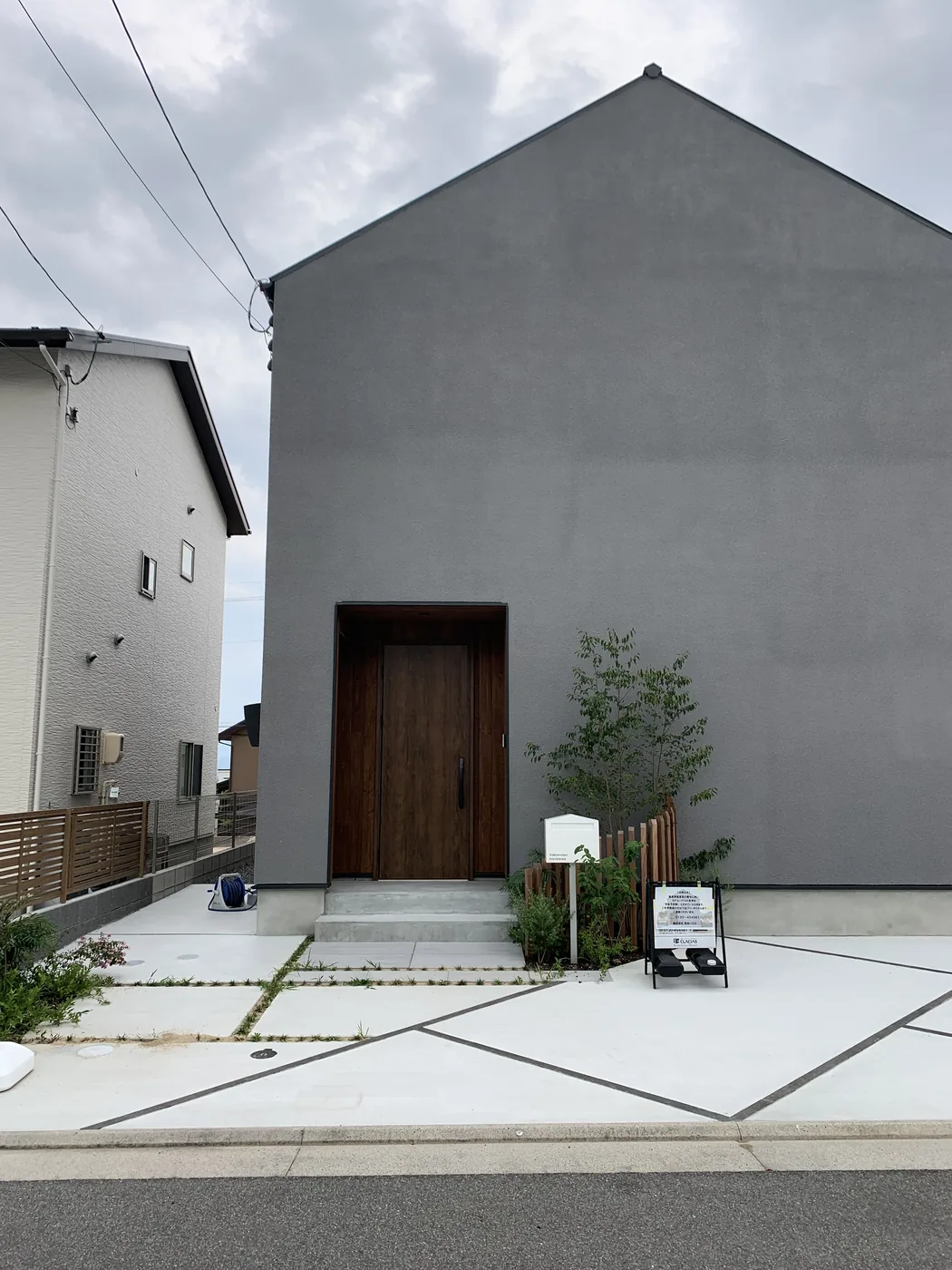 建物正面から見る玄関前植栽と小さな木の囲い